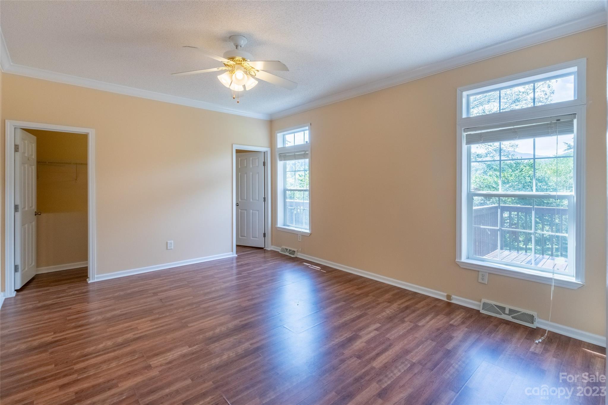 407 Monteith Gap Road Cullowhee, NC 28723 - Photo 16 of 27 a view of an empty room with wooden floor and a window