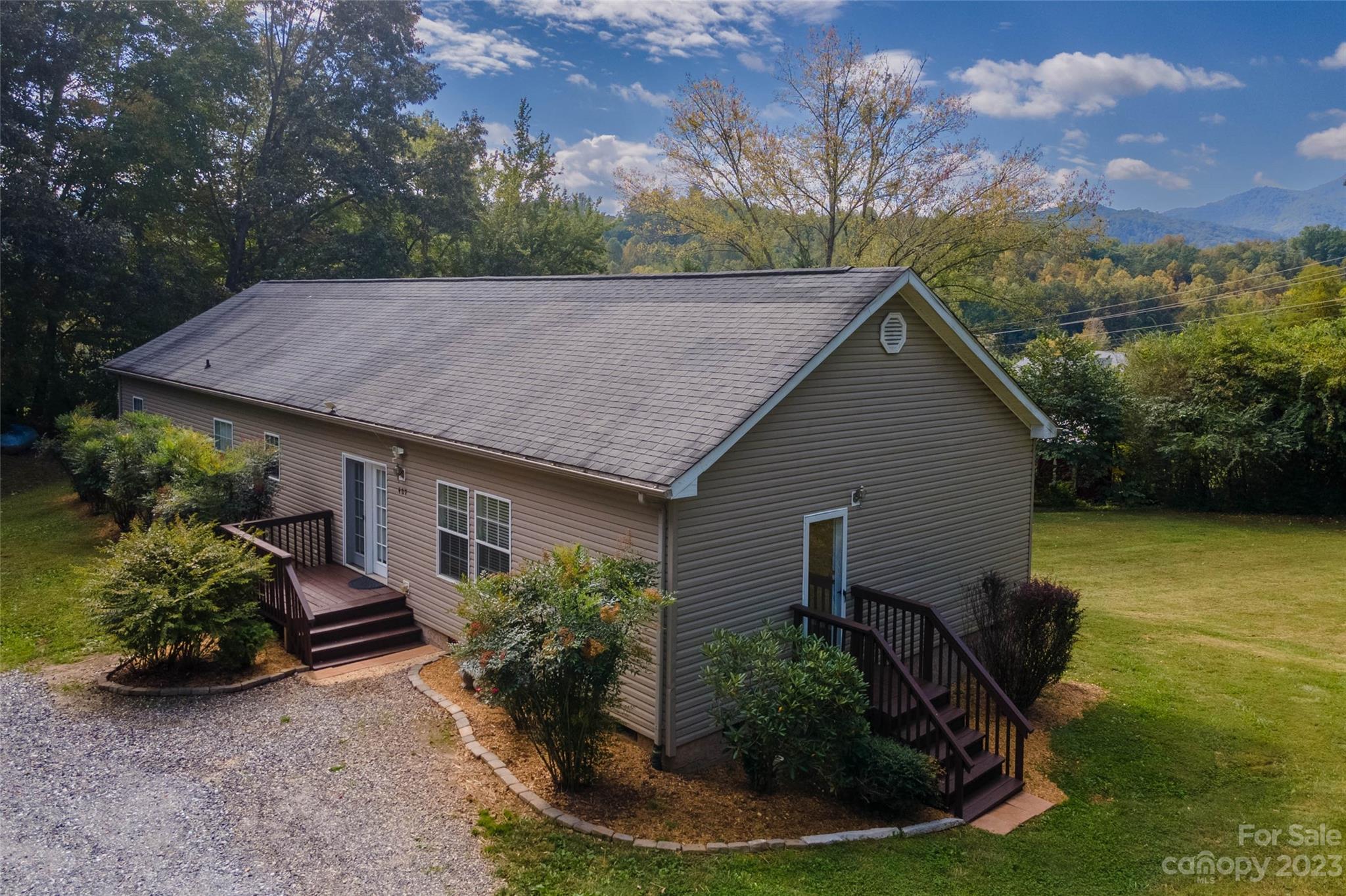 407 Monteith Gap Road Cullowhee, NC 28723 - Photo 2 of 27 a view of a house with backyard and garden