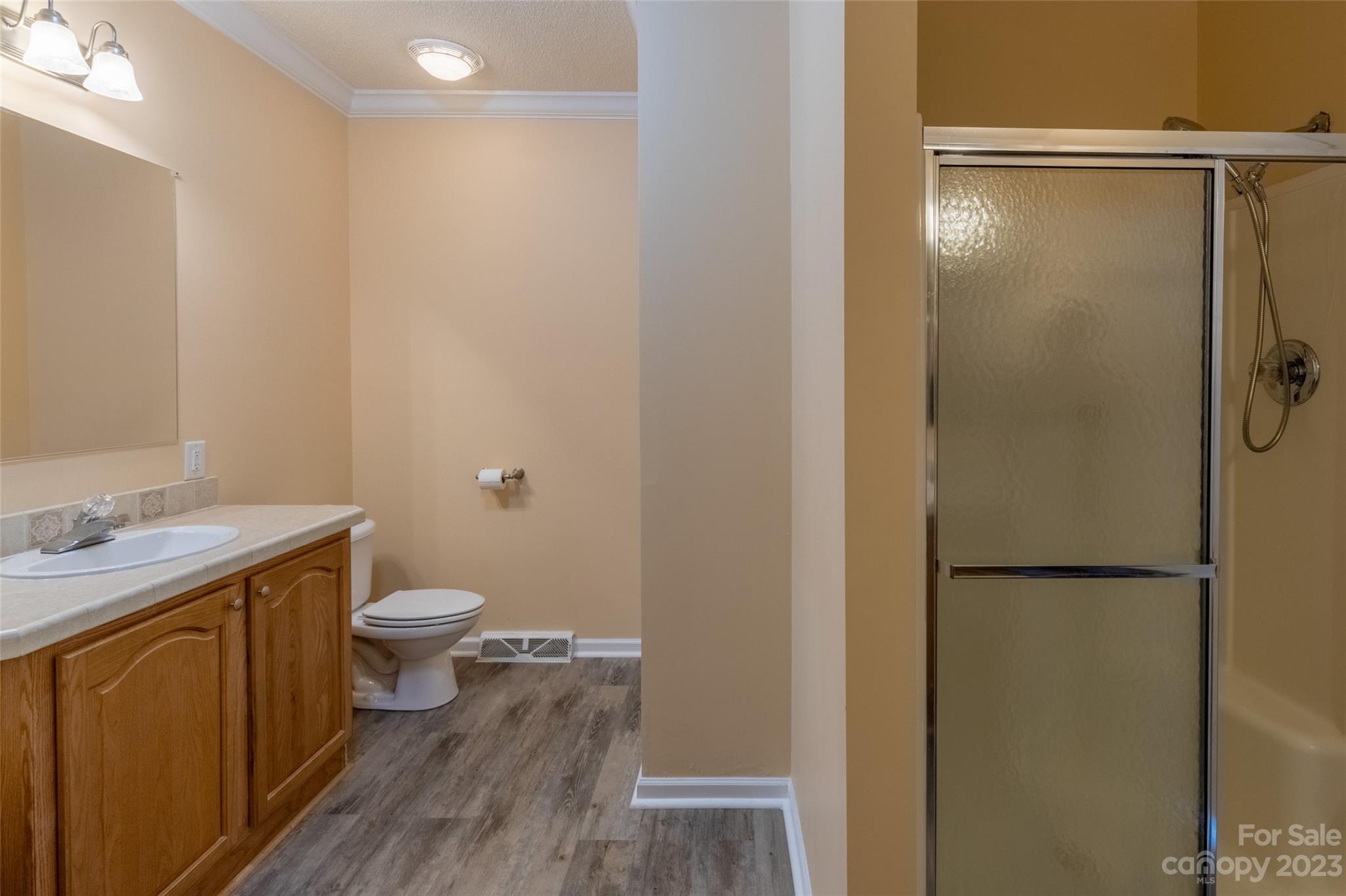 407 Monteith Gap Road Cullowhee, NC 28723 - Photo 21 of 27 a bathroom with a granite countertop sink toilet and shower