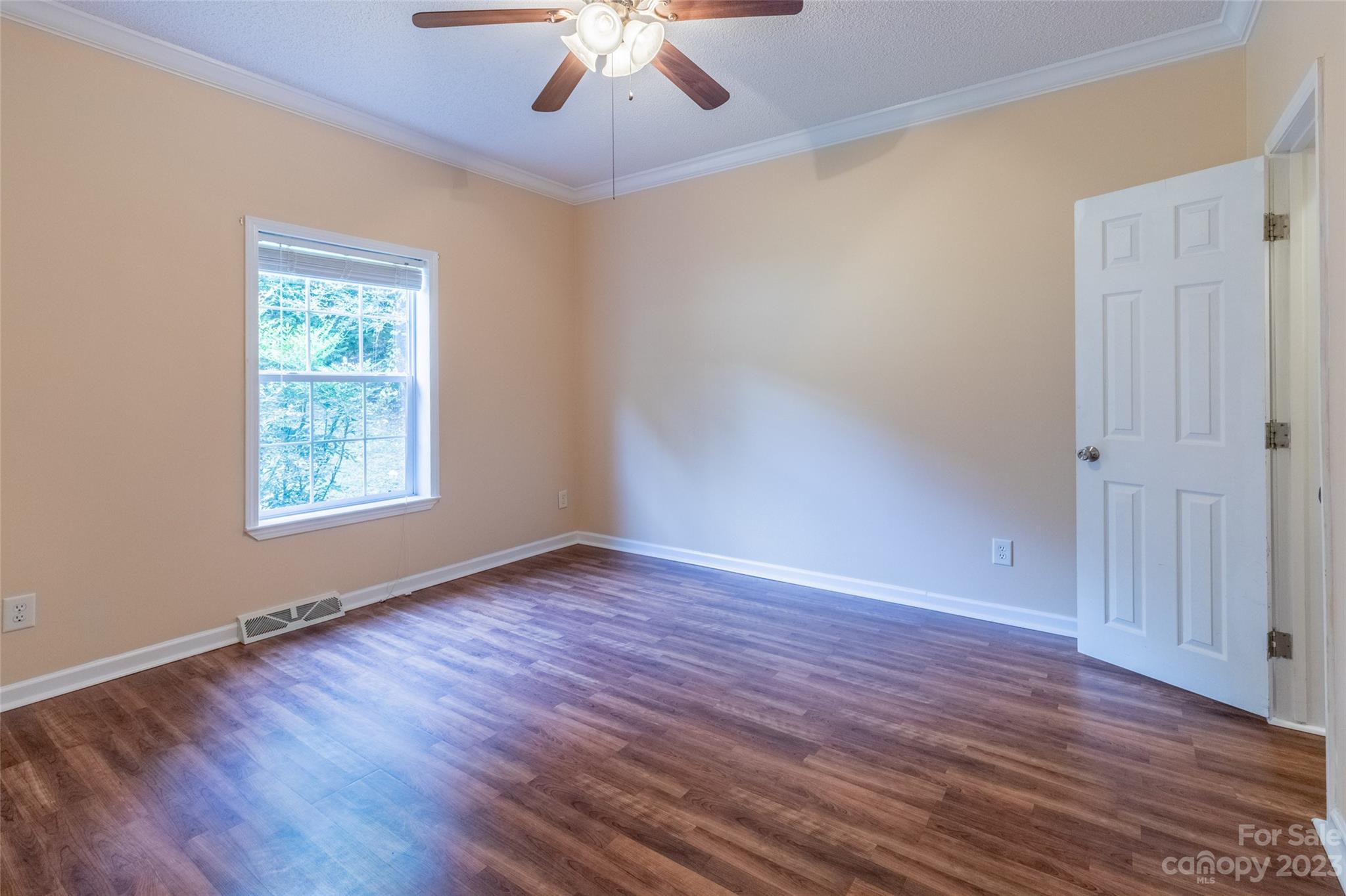 407 Monteith Gap Road Cullowhee, NC 28723 - Photo 22 of 27 a view of an empty room with wooden floor and a window