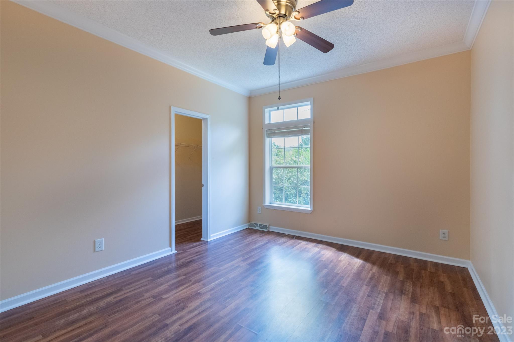 407 Monteith Gap Road Cullowhee, NC 28723 - Photo 23 of 27 an empty room with wooden floor fan and windows