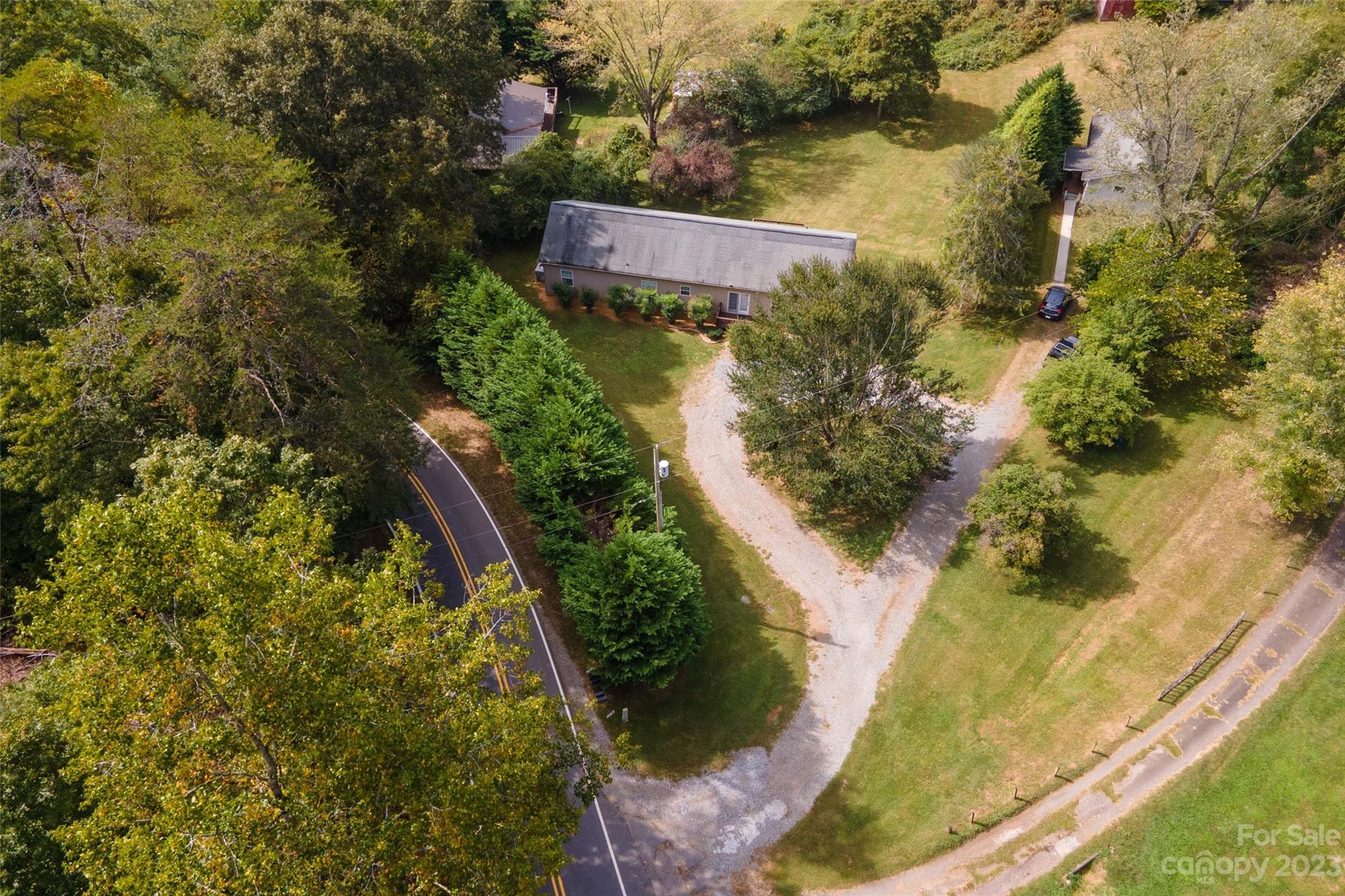 407 Monteith Gap Road Cullowhee, NC 28723 - Photo 3 of 27 an aerial view of residential house with outdoor space and trees all around
