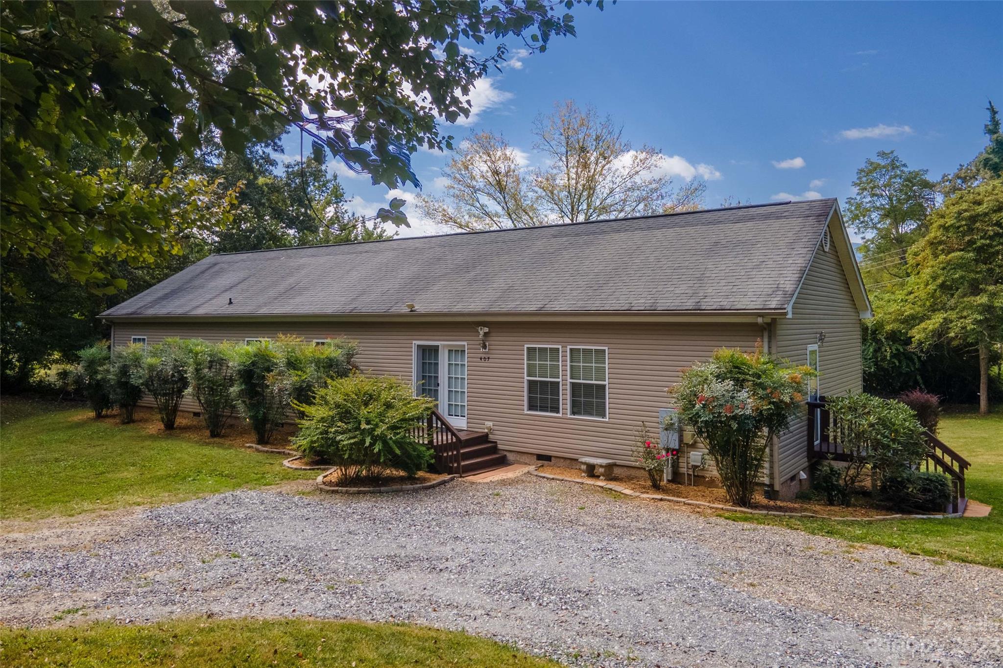 407 Monteith Gap Road Cullowhee, NC 28723 - Photo 4 of 27 a front view of a house with garden