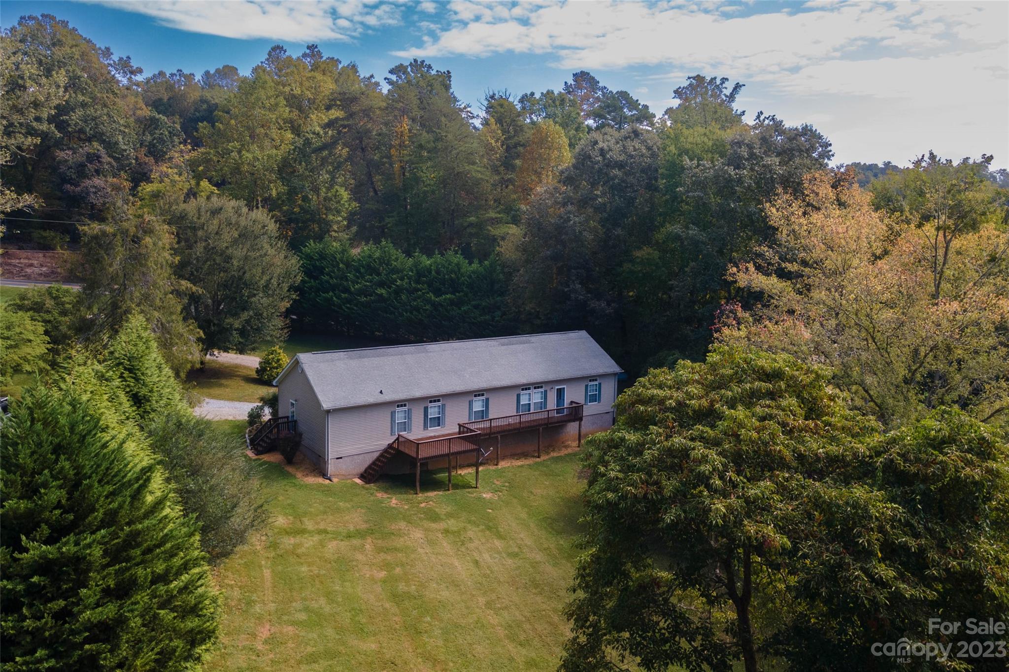 407 Monteith Gap Road Cullowhee, NC 28723 - Photo 5 of 27 an aerial view of a house with swimming pool and large trees