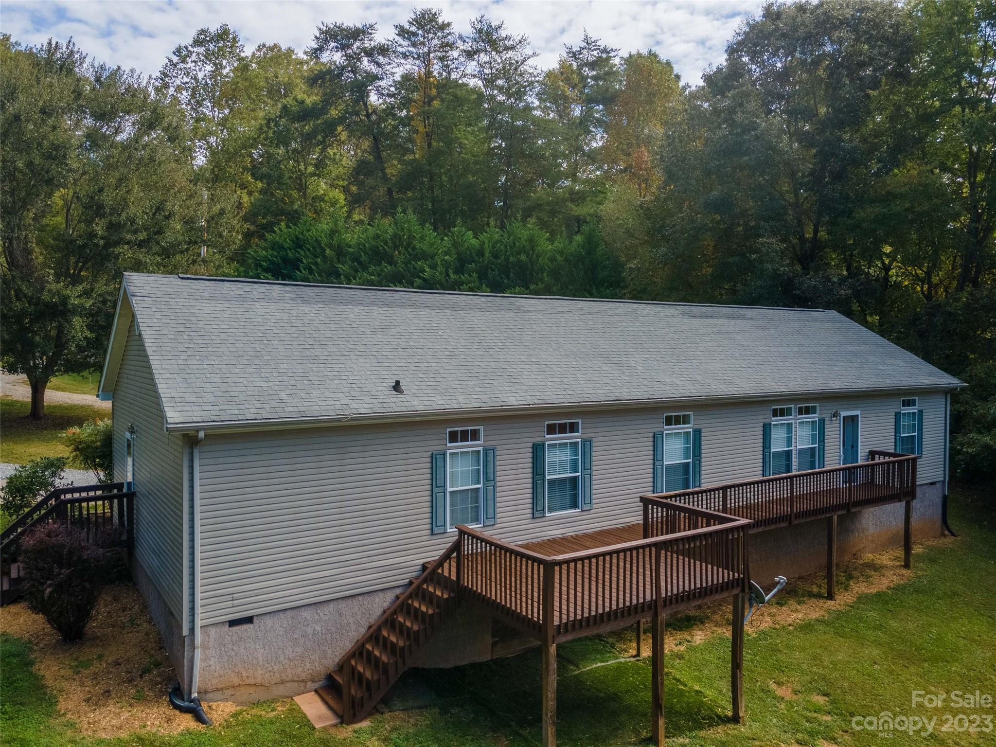 407 Monteith Gap Road Cullowhee, NC 28723 - Photo 6 of 27 a view of a house with pool and chairs