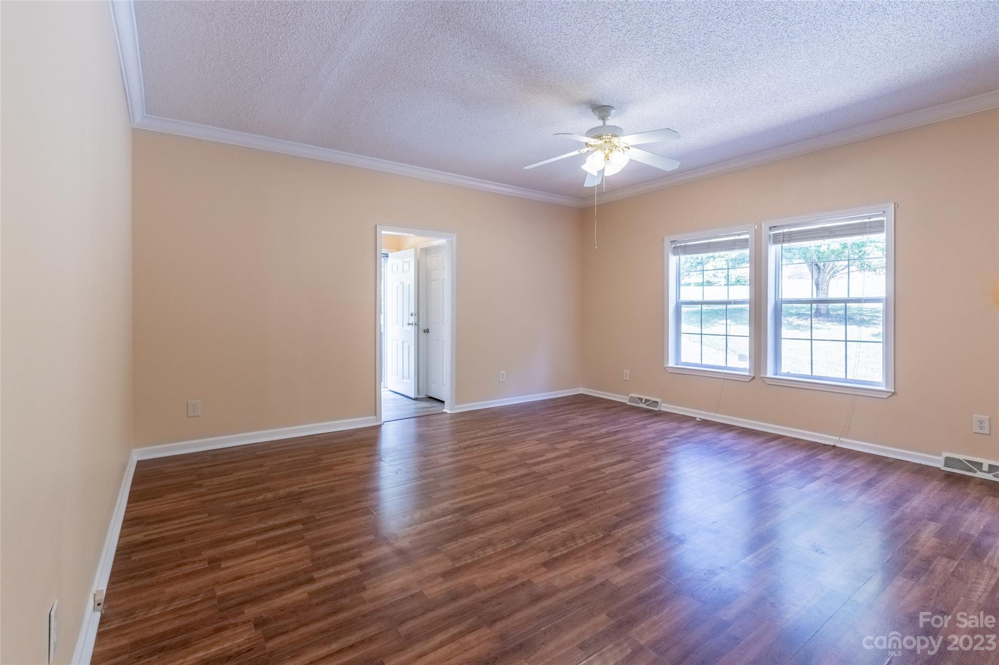 407 Monteith Gap Road Cullowhee, NC 28723 - Photo 8 of 27 a view of an empty room with wooden floor and a window
