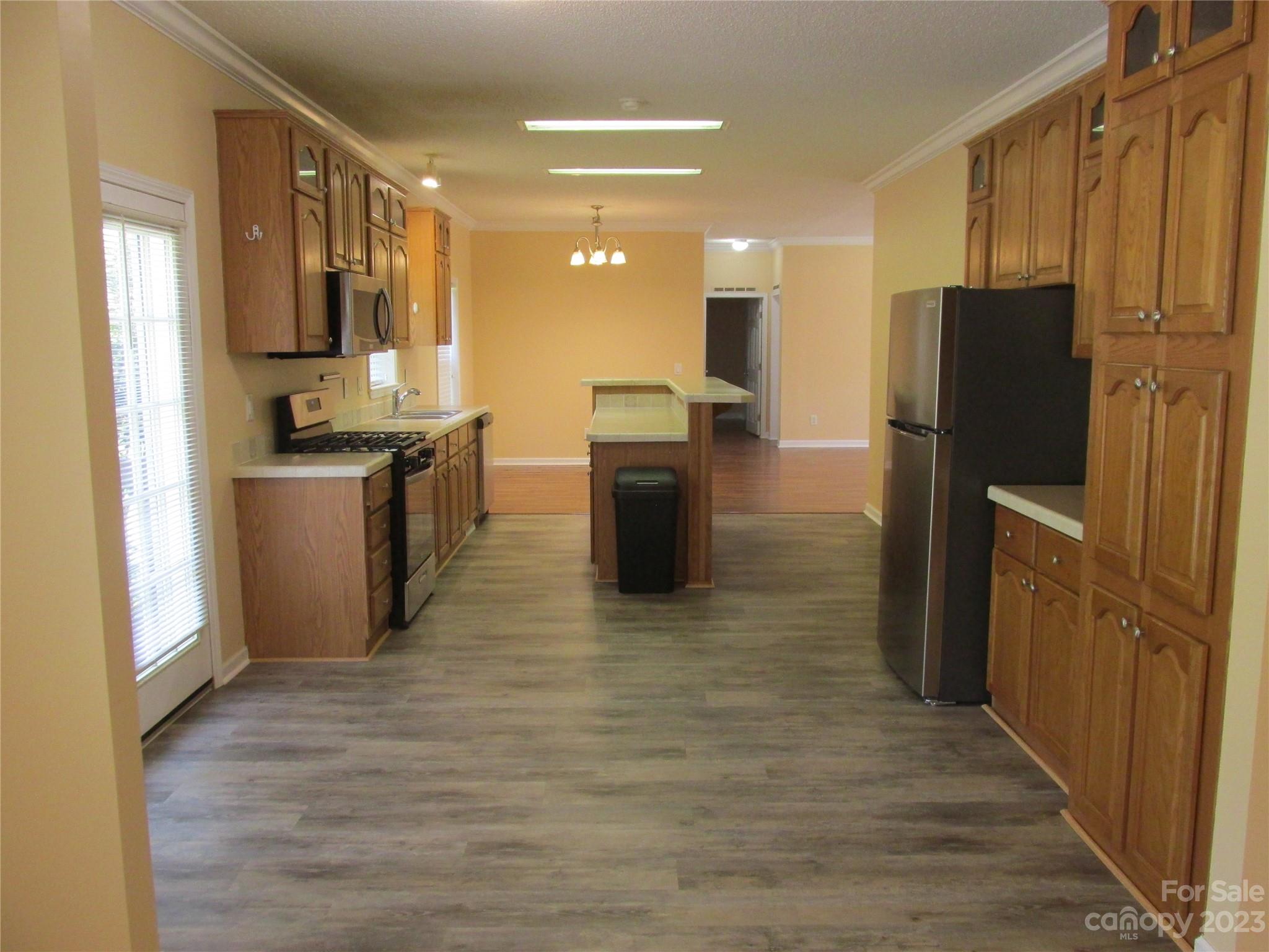 407 Monteith Gap Road Cullowhee, NC 28723 - Photo 10 of 27 a kitchen with stainless steel appliances granite countertop a refrigerator a stove top oven a sink and dishwasher