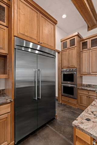 2464 East Granite Way St. George, UT 84790 - Photo 53 of 106 Kitchen with finished concrete floors, stainless steel appliances, dark stone counters, glass insert cabinets, and recessed lighting
