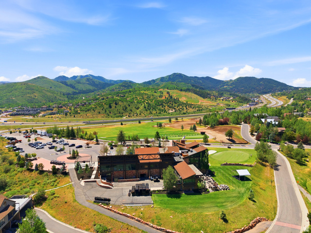 3148 Lower Saddleback Road Park City, UT 84098 - Photo 65 of 67 Mountainous landscape featuring a large commercial building with multiple rooflines, an expansive parking area, paved roads, and a manicured golf course green