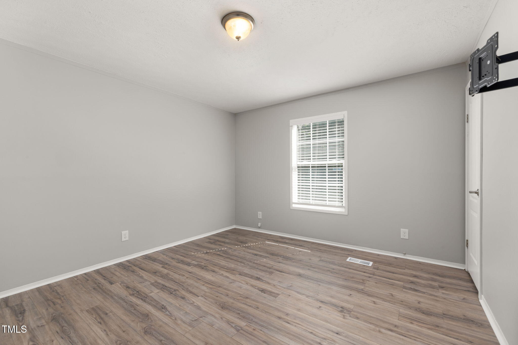 4073 Pine Ridge Road Franklinton, NC 27525 - Photo 12 of 24 wooden floor in an empty room with a window