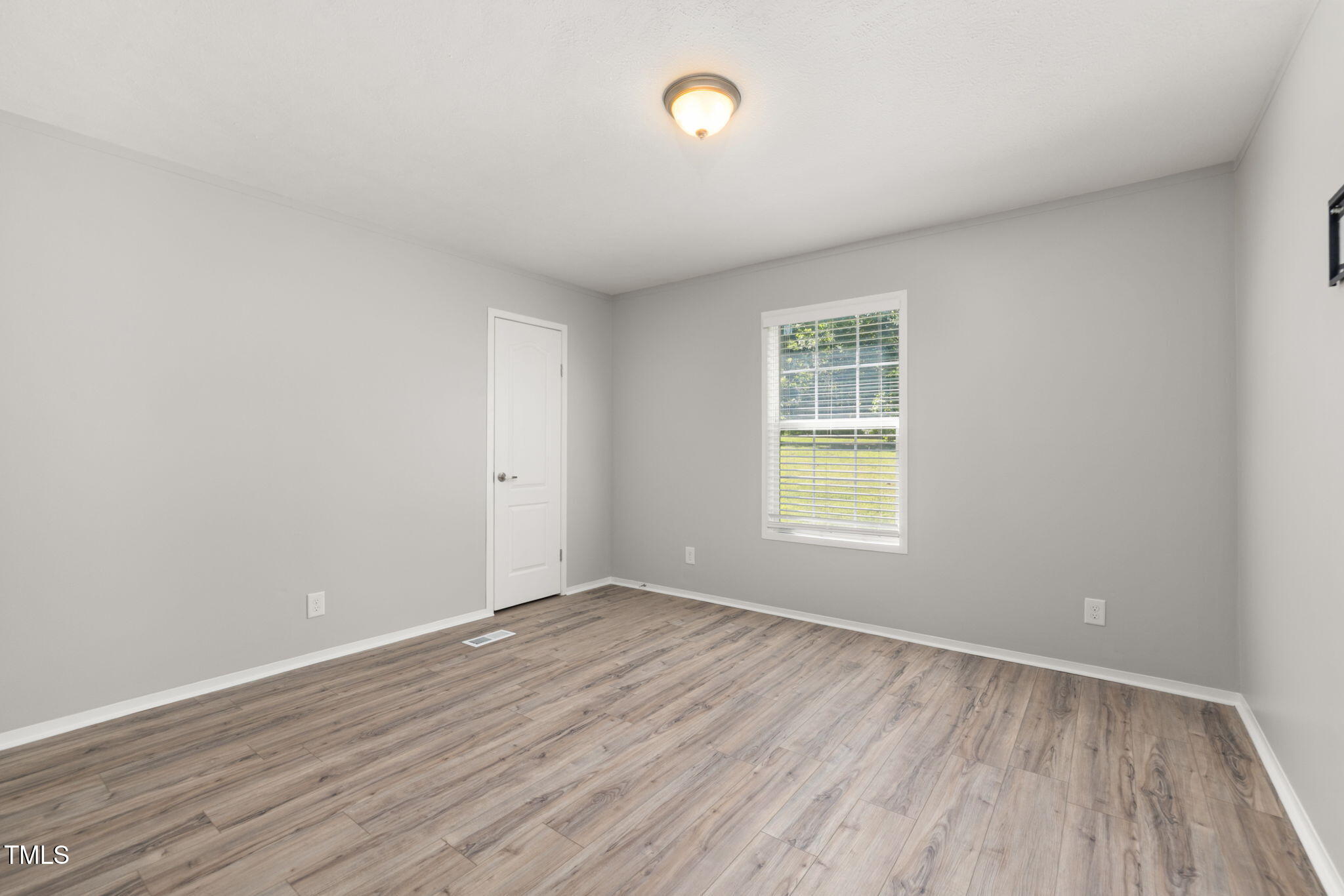 4073 Pine Ridge Road Franklinton, NC 27525 - Photo 13 of 24 wooden floor in an empty room with a window