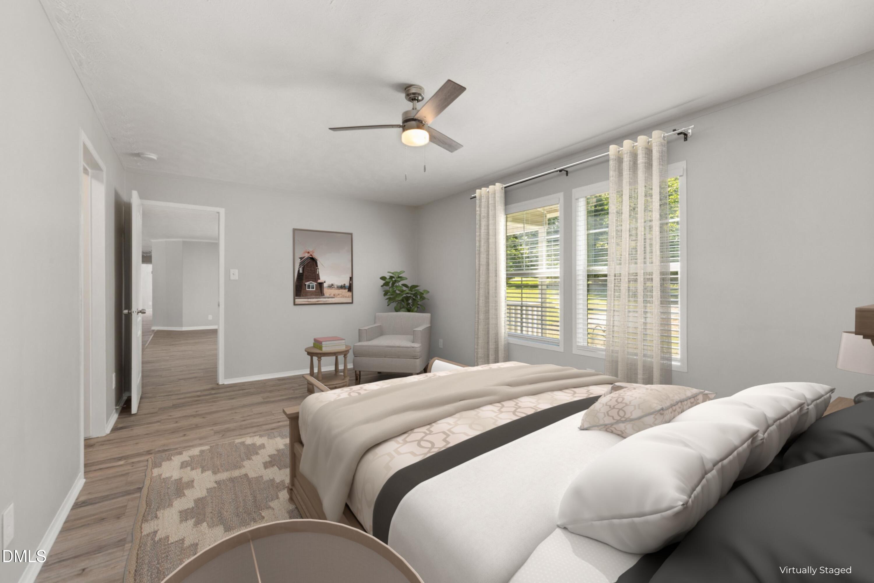 4073 Pine Ridge Road Franklinton, NC 27525 - Photo 16 of 24 a bedroom with a large bed and a chandelier