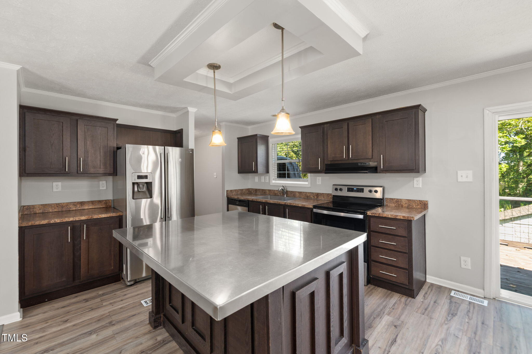4073 Pine Ridge Road Franklinton, NC 27525 - Photo 5 of 24 a kitchen with stainless steel appliances granite countertop a kitchen island a stove a refrigerator a sink a center island and a window