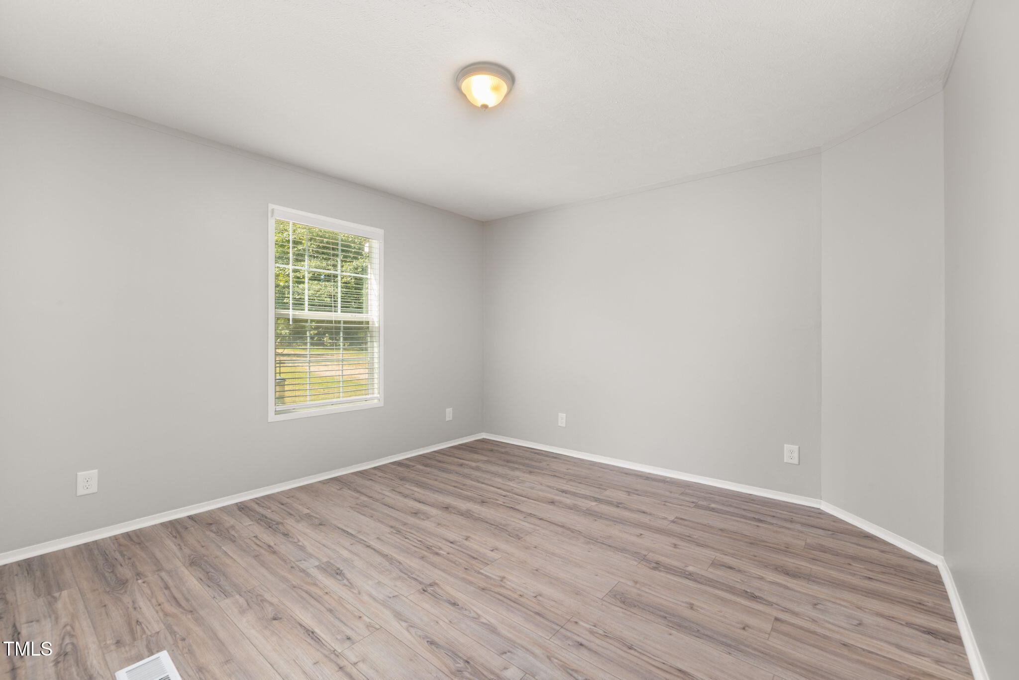 4073 Pine Ridge Road Franklinton, NC 27525 - Photo 9 of 24 an empty room with wooden floor and windows