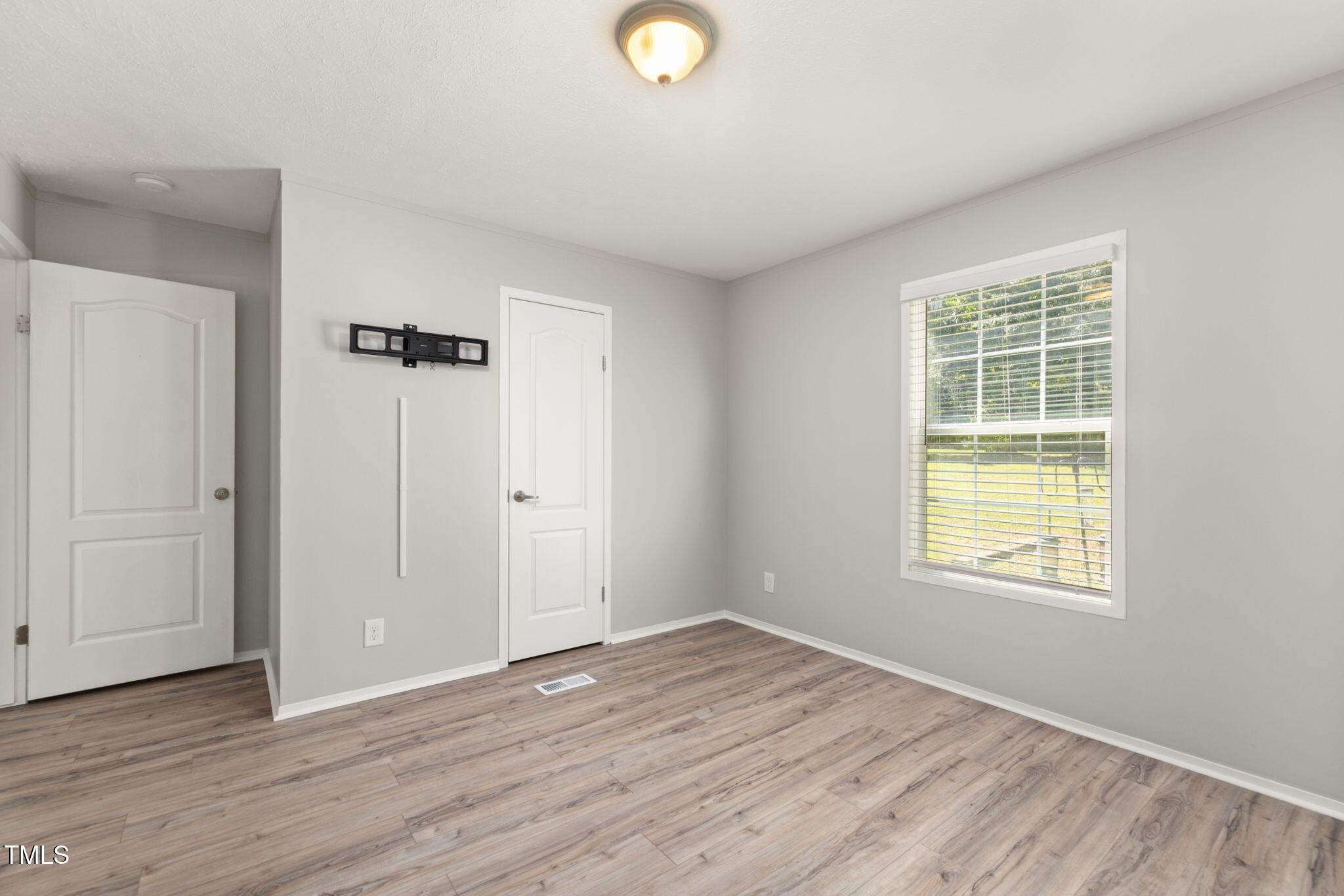 4073 Pine Ridge Road Franklinton, NC 27525 - Photo 10 of 24 an empty room with wooden floor and windows