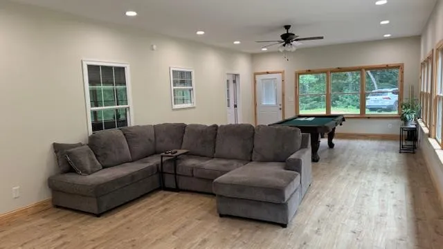 a living room with furniture and a wooden floor