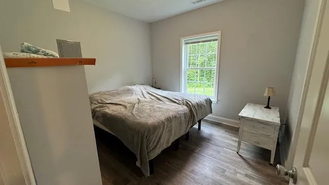 a bedroom with a bed and window