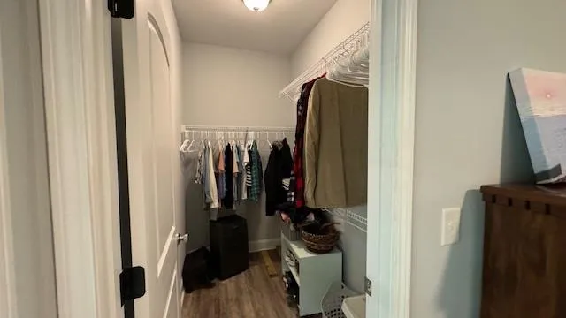 a bathroom with a sink a toilet a mirror and shower