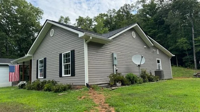 a view of a house with a yard and wooden fence