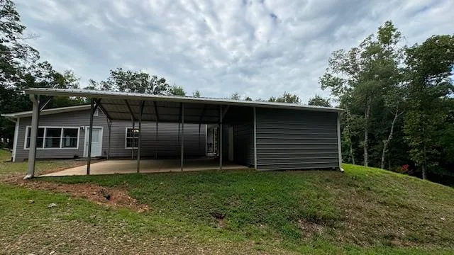 a view of a house with a backyard