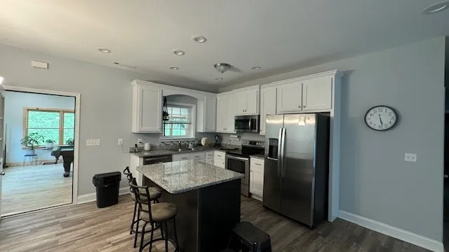 a kitchen with refrigerator and window
