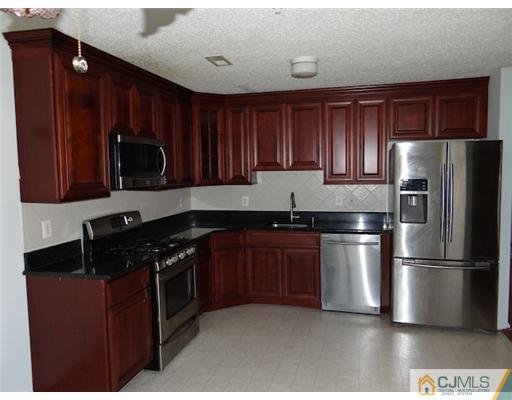 241 Prestwick Way Edison, NJ 08820 - Photo 4 of 9 a kitchen with stainless steel appliances granite countertop a refrigerator stove a sink and dishwasher
