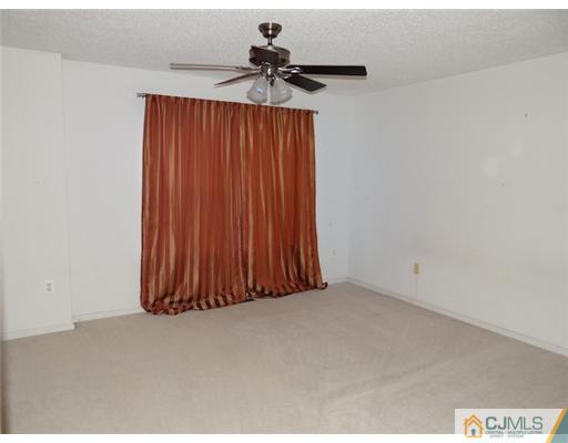 241 Prestwick Way Edison, NJ 08820 - Photo 6 of 9 a view of a room with a ceiling fan