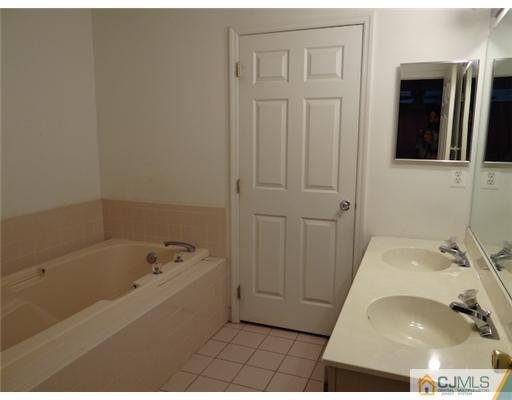 241 Prestwick Way Edison, NJ 08820 - Photo 7 of 9 a bathroom with a bathtub and a shower