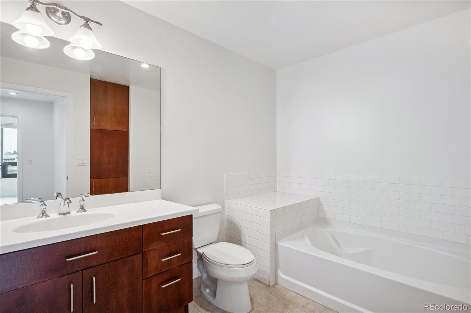 2990 East 17th Avenue, Unit 803 Denver, CO 80206 - Photo 12 of 29 a bathroom with a sink a toilet and bathtub