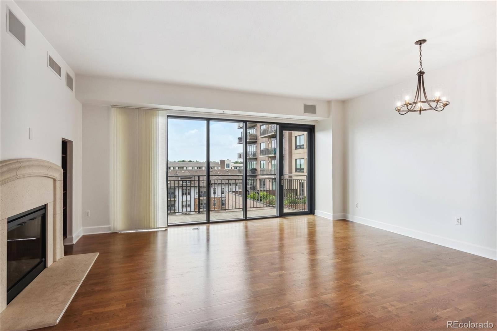 2990 East 17th Avenue, Unit 803 Denver, CO 80206 - Photo 8 of 29 a view of a livingroom with wooden floor and a fireplace