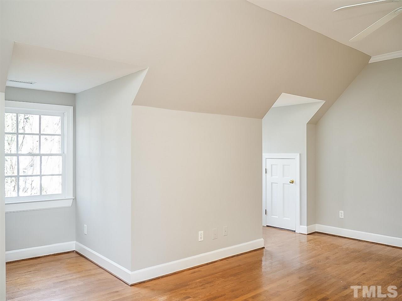 2517 Winterbury Court Raleigh, NC 27607 - Photo 11 of 24 an empty room with wooden floor and windows