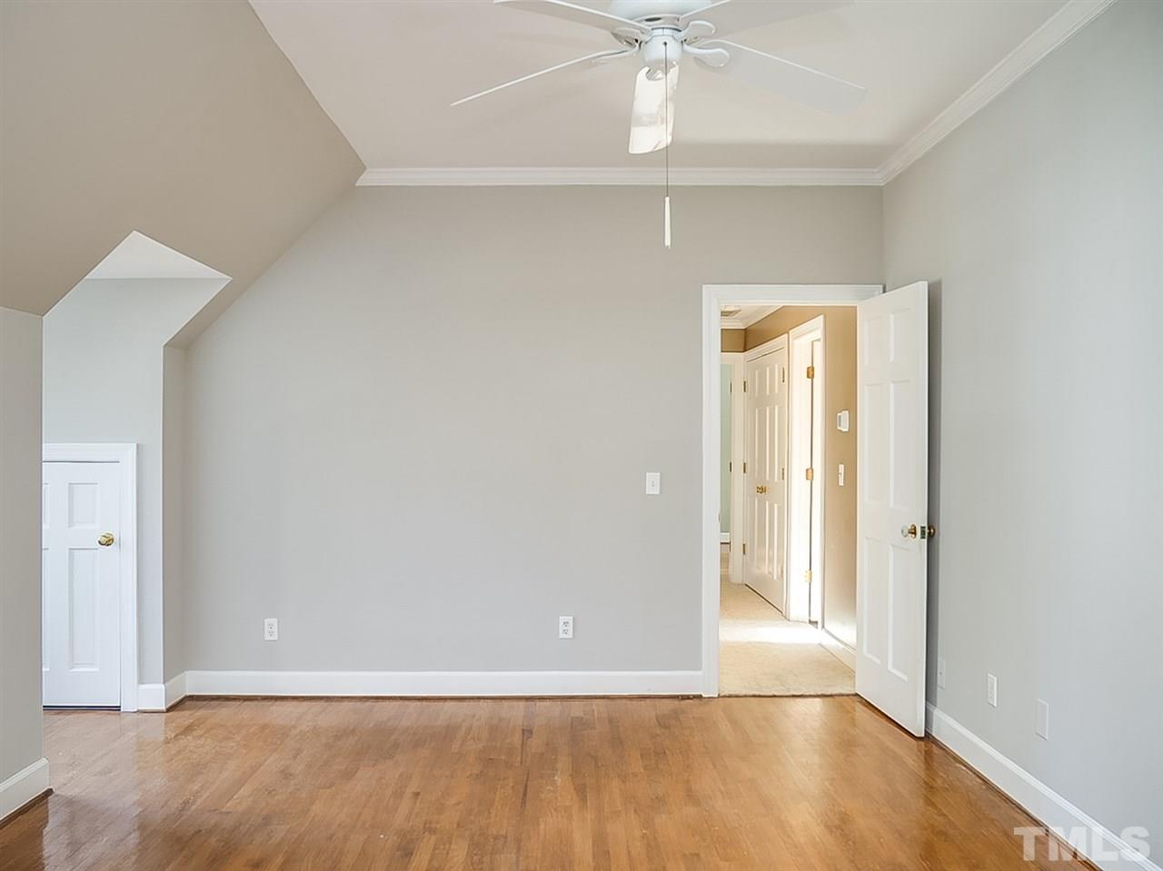 2517 Winterbury Court Raleigh, NC 27607 - Photo 12 of 24 an empty room with wooden floor and fan