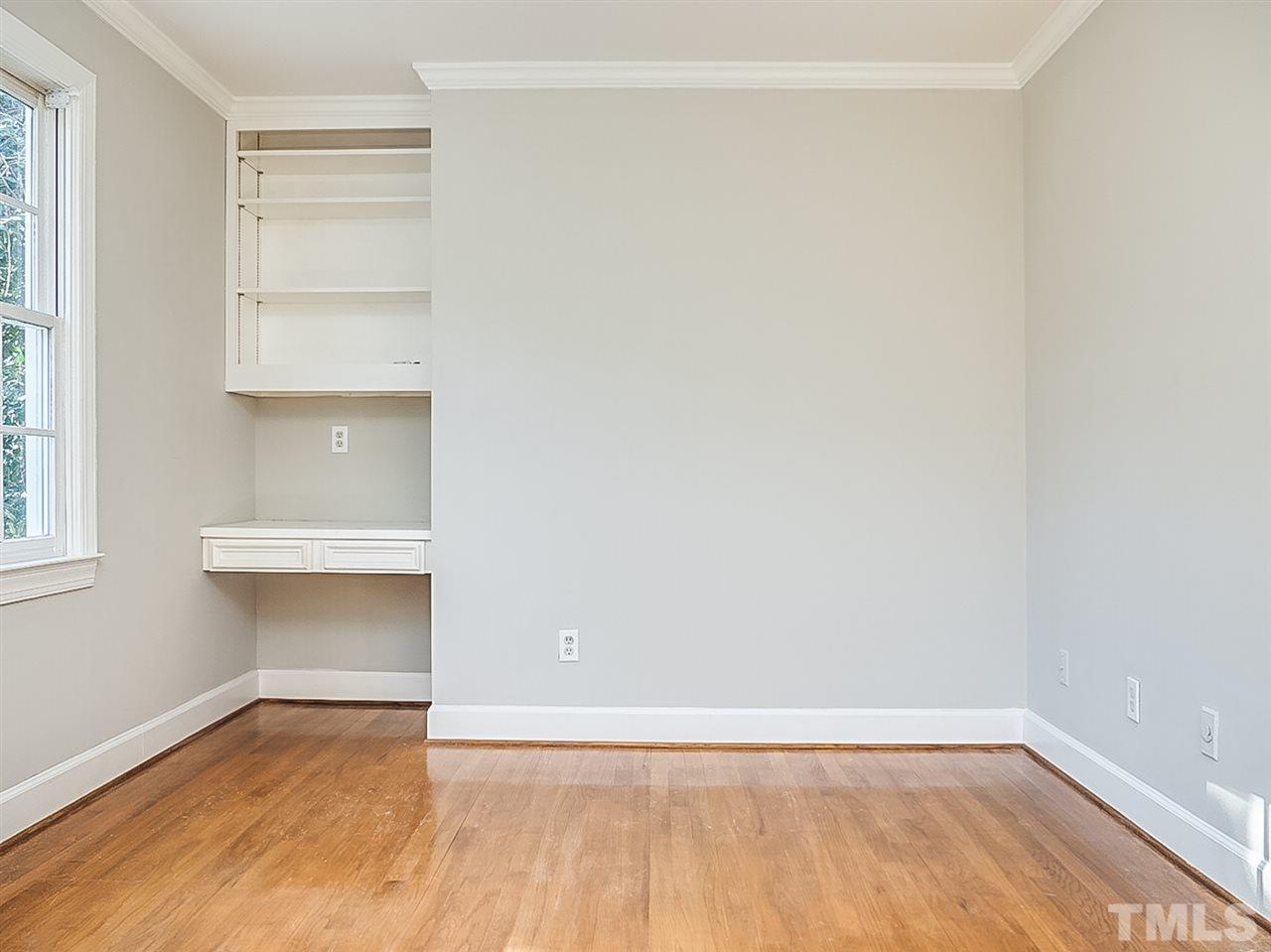 2517 Winterbury Court Raleigh, NC 27607 - Photo 15 of 24 a view of an empty room with a window and wooden floor