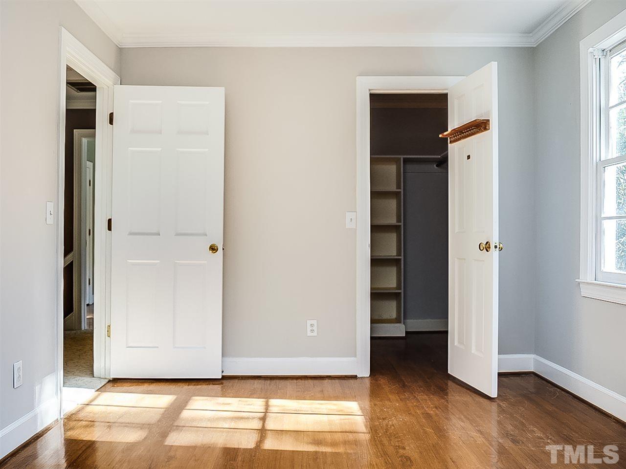 2517 Winterbury Court Raleigh, NC 27607 - Photo 16 of 24 an empty room with wooden floor closet and windows