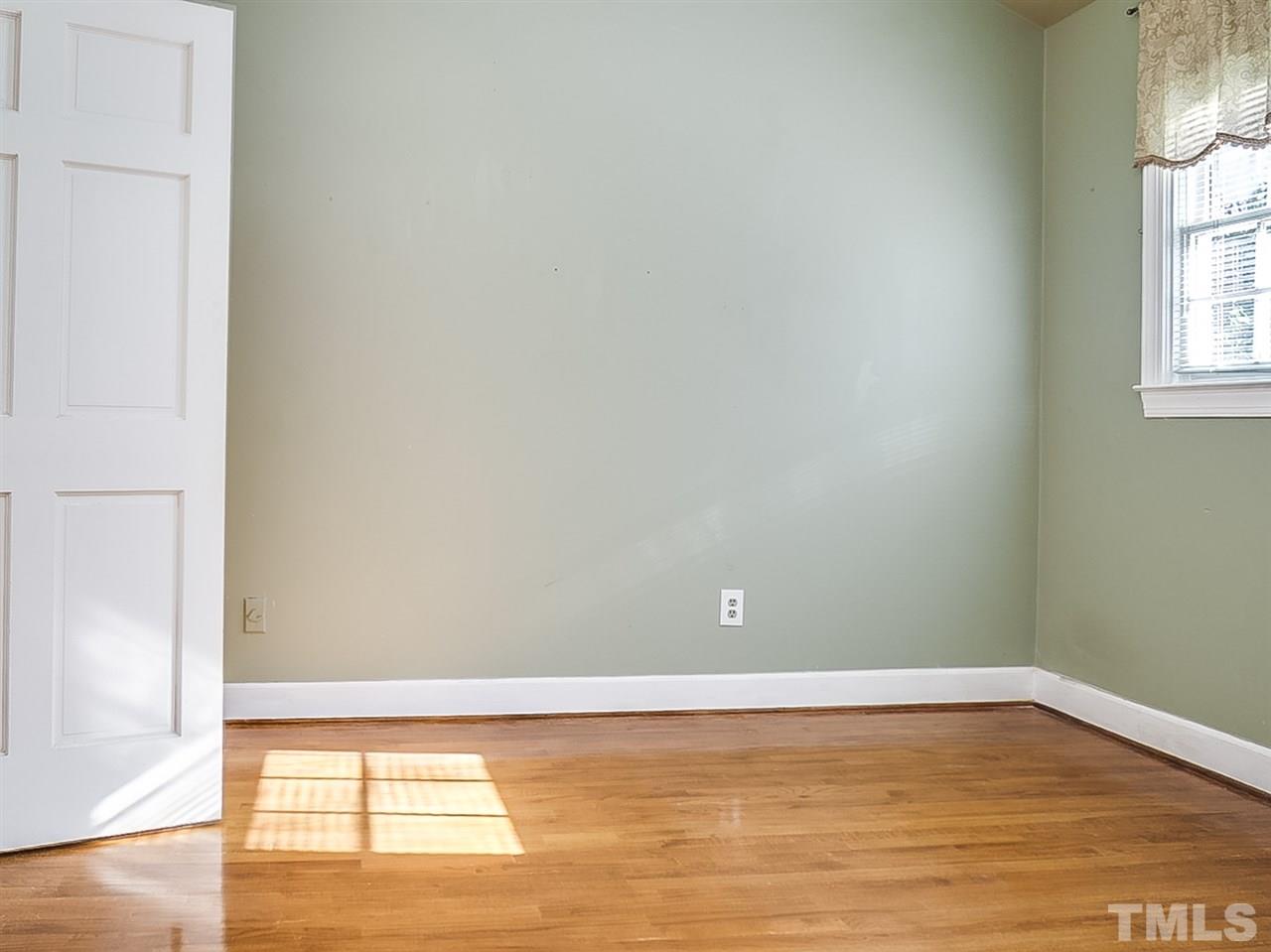 2517 Winterbury Court Raleigh, NC 27607 - Photo 19 of 24 a view of a room with wooden floor and windows