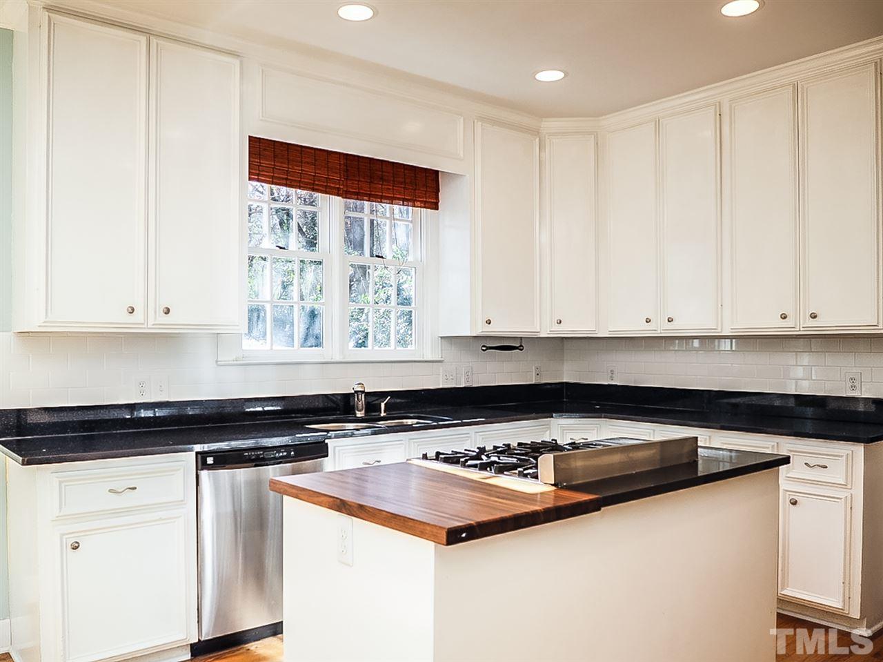 2517 Winterbury Court Raleigh, NC 27607 - Photo 3 of 24 a kitchen with granite countertop a sink and white cabinets