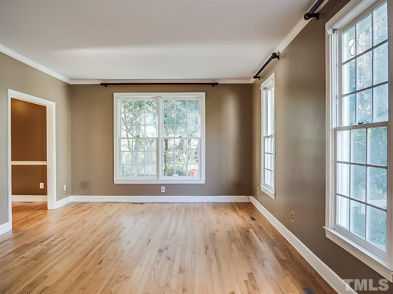 2517 Winterbury Court Raleigh, NC 27607 - Photo 7 of 24 an empty room with wooden floor and windows