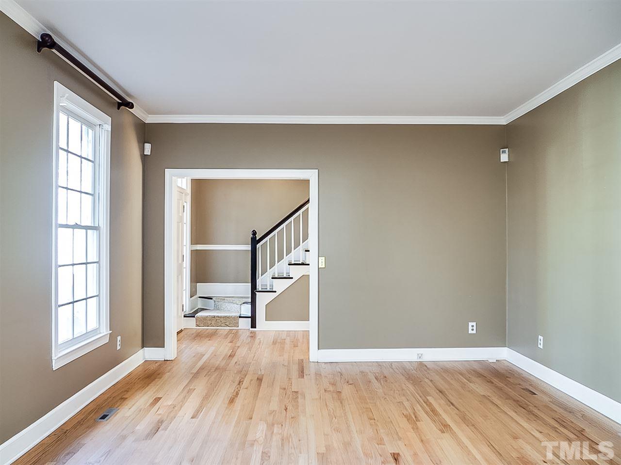 2517 Winterbury Court Raleigh, NC 27607 - Photo 8 of 24 wooden floor in an empty room with a window
