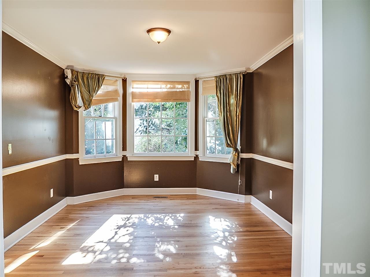 2517 Winterbury Court Raleigh, NC 27607 - Photo 9 of 24 a view of an empty room with a window and wooden floor
