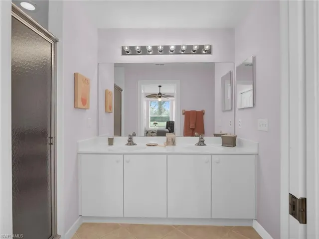 a bedroom with a bed a couch and a chandelier