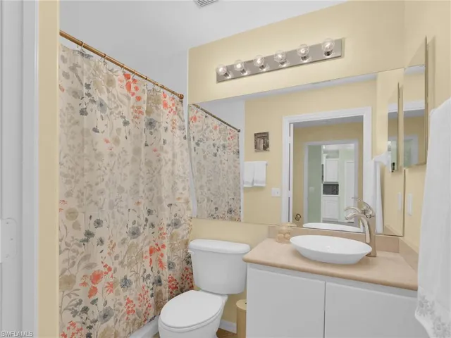 a living room filled with furniture and a floor to ceiling window