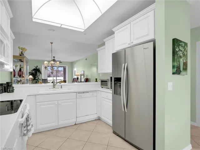 a kitchen with stainless steel appliances a refrigerator sink and cabinets
