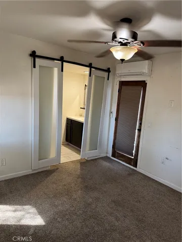 a view of an empty room with a mirror