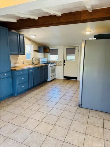 a large kitchen with a sink and cabinets