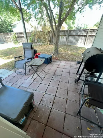 a roof deck with table and chairs and wooden floor
