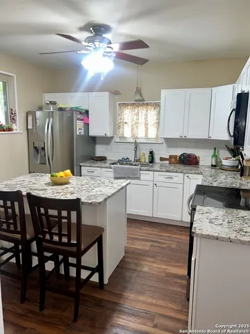 a kitchen with a sink a stove a refrigerator and a refrigerator