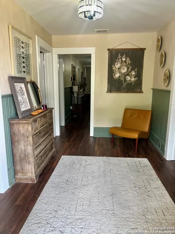 a living room with furniture and a mirror