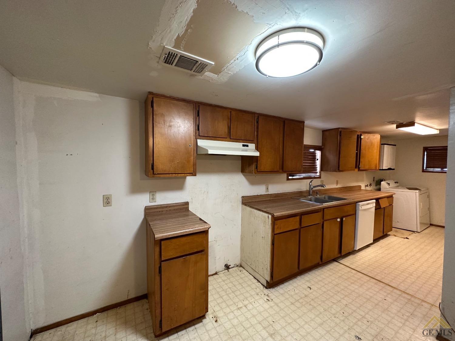Undisclosed Address Taft, CA 93268 - Photo 4 of 22 a kitchen with stainless steel appliances granite countertop a stove a sink and a refrigerator