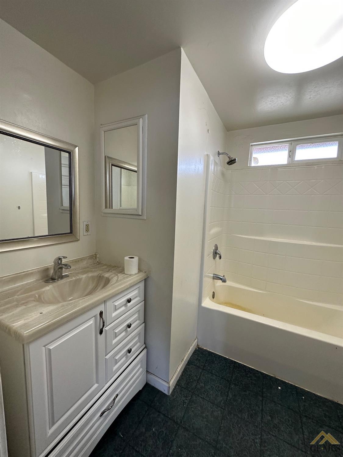 Undisclosed Address Taft, CA 93268 - Photo 7 of 22 a spacious bathroom with a granite countertop sink a toilet mirror and a bathtub