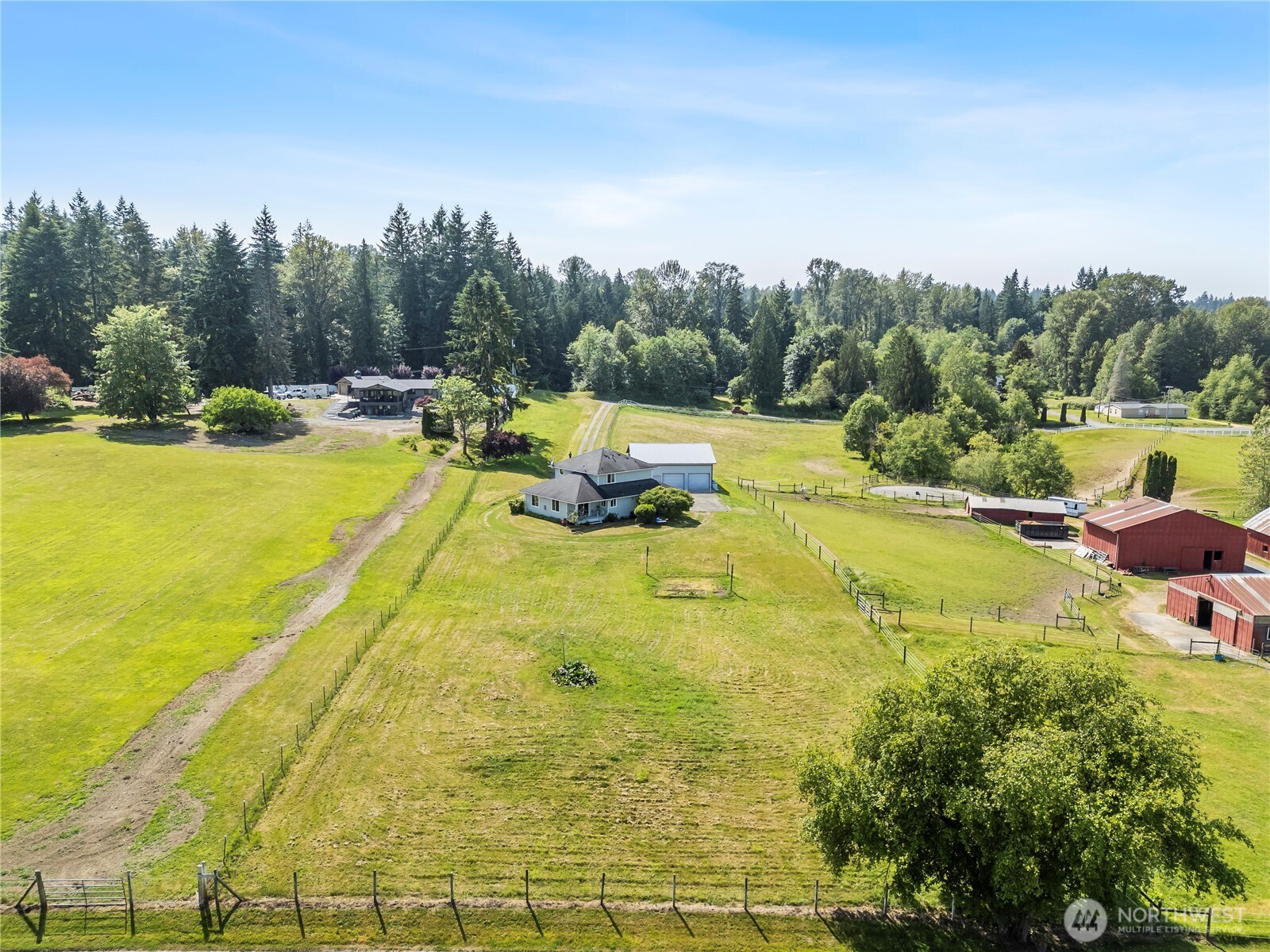 18927 Fales Road Snohomish, WA 98296 - Photo 15 of 18 a view of a swimming pool with lawn chairs and wooden fence